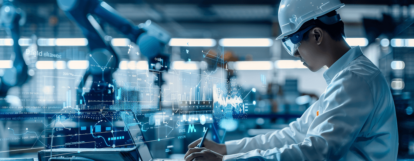 Manufacturing engineer working at a laptop in a modern industrial facility
